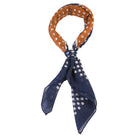 blue and orange male bandana with white dots tied